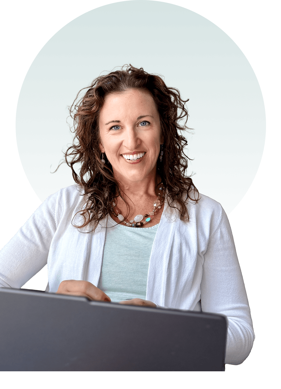 Smiling woman with curly hair in a light cardigan.